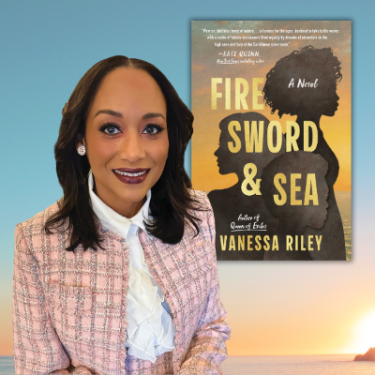 Vanessa Riley A person wearing a light pink tweed jacket and white ruffled blouse stands in front of a large book cover. The book displayed is titled Fire, Sword & Sea: A Novel by Vanessa Riley, featuring silhouettes of three figures against a sunset-colored background.