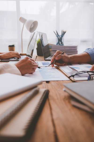 Development Review Application Information cropped image of two peoples hands reviewing documents on a table