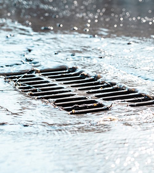 Water flowing into a sewer drain