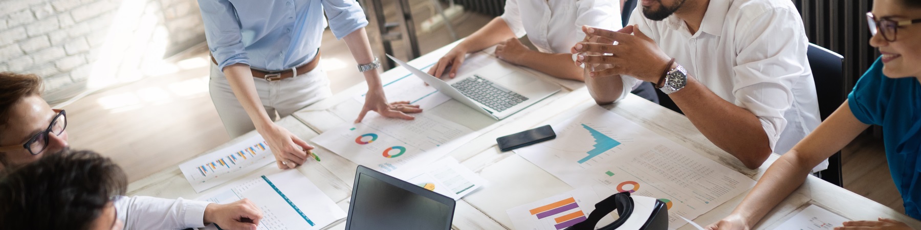 people at a table with business documents spread out